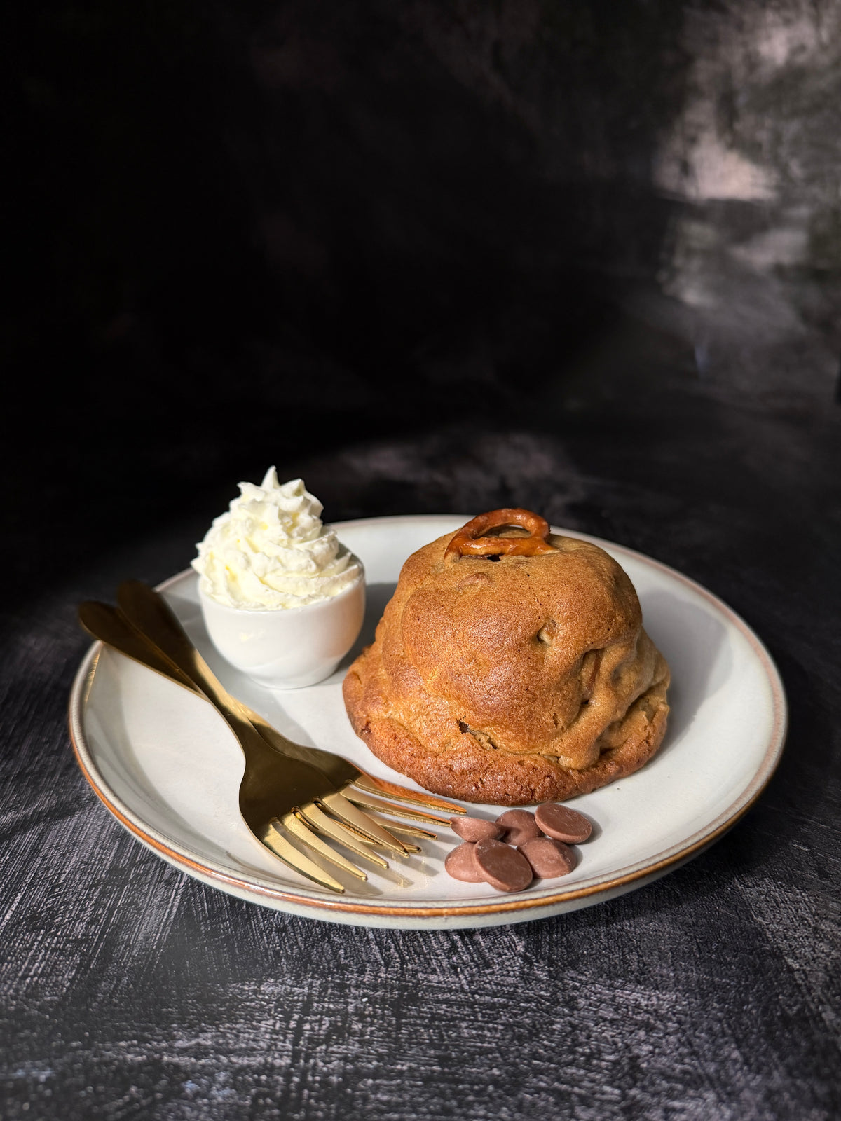 Caramel and Pretzel cookie served as a dessert with whipped cream and Belgian chocolate, handmade in Dartmoor by Black Bird Bakers