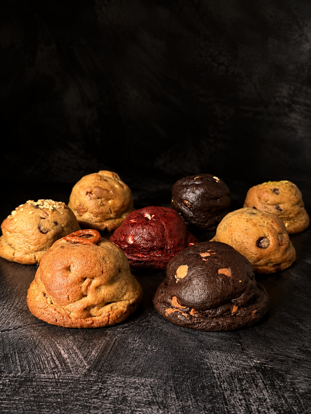 The Belgian gooey chocolate chip cookie displayed with an assortment of thick handmade cookies, baked in Dartmoor by Black Bird Bakers.