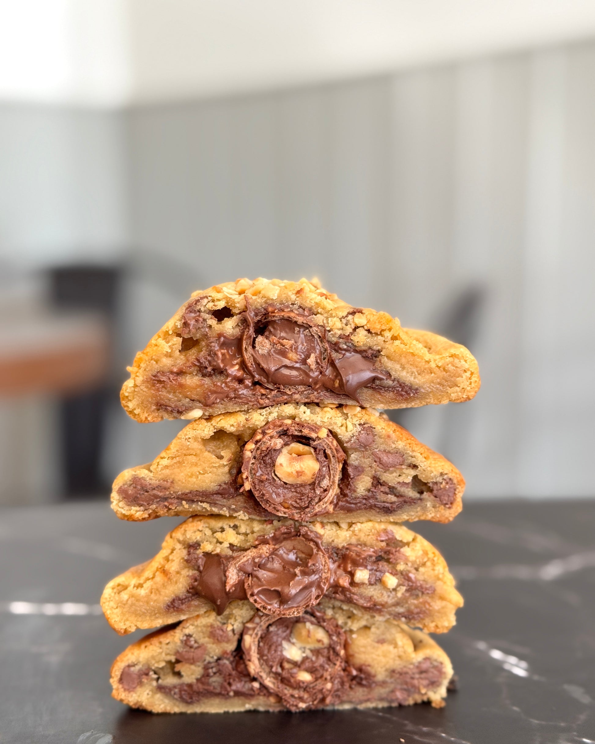 Rocher Royal NYC cookie stacked to show molten hazelnut centre and Ferrero Rocher filling