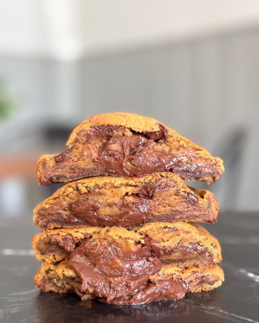 The Belgian cookie stacked to show Belgian chocolate chips and molten Belgian chocolate ganache centre by Black Bird Bakers