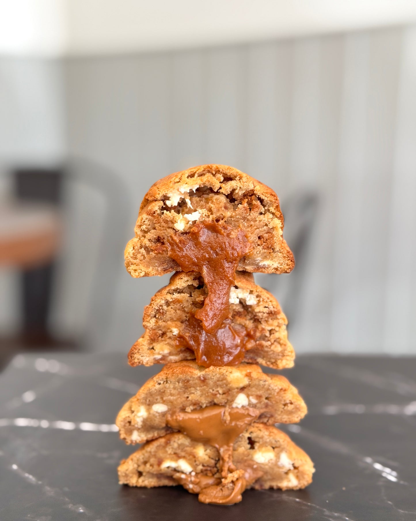 Biscoff Billionaire NYC cookie stacked to show gooey Biscoff centre, caramelised biscuit pieces and white chocolate chips by Black Bird Bakers 