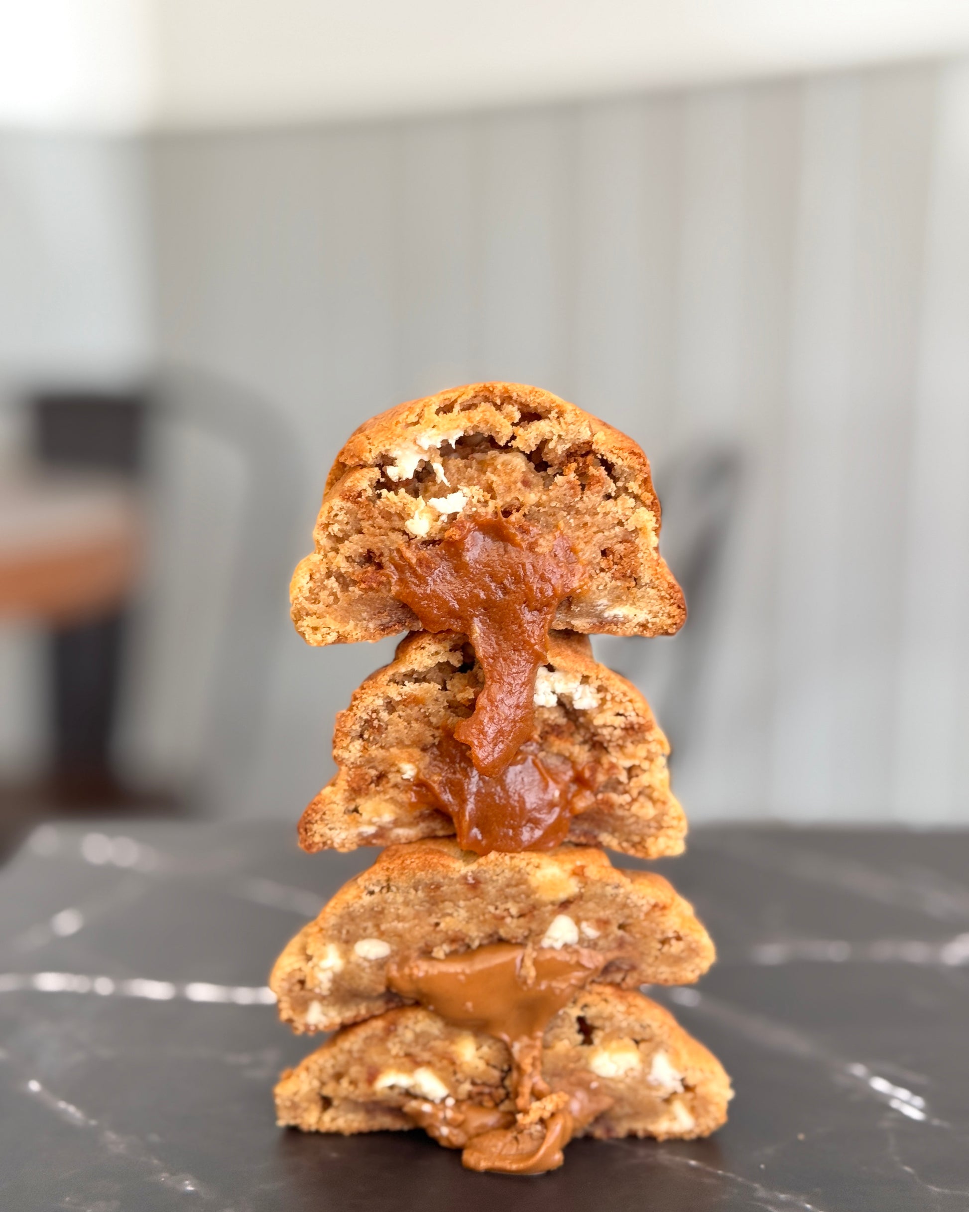 Biscoff Billionaire NYC cookie stacked to show gooey Biscoff centre, caramelised biscuit pieces and white chocolate chips by Black Bird Bakers 