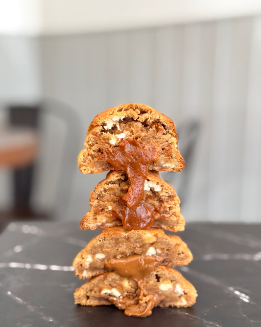 Biscoff Billionaire NYC cookie stacked to show gooey Biscoff centre, caramelised biscuit pieces and white chocolate chips by Black Bird Bakers 