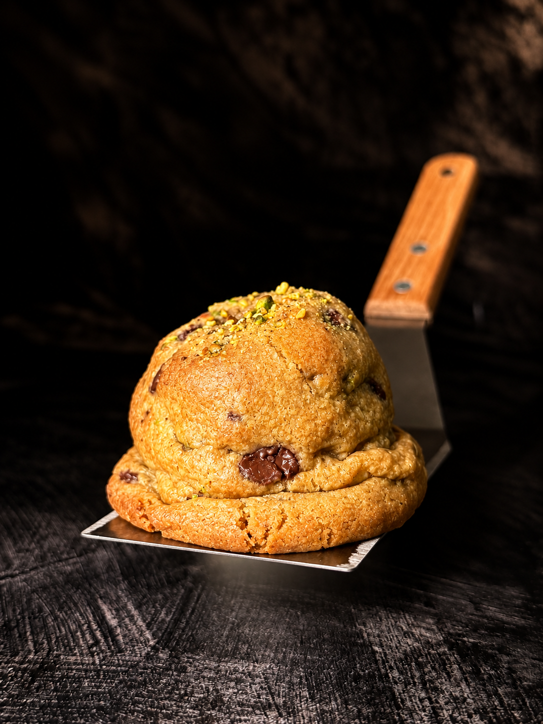 Thick handmade Pistachio Luxe cookie with Belgian chocolate and chopped pistachios, baked in Dartmoor by Black Bird Bakers.