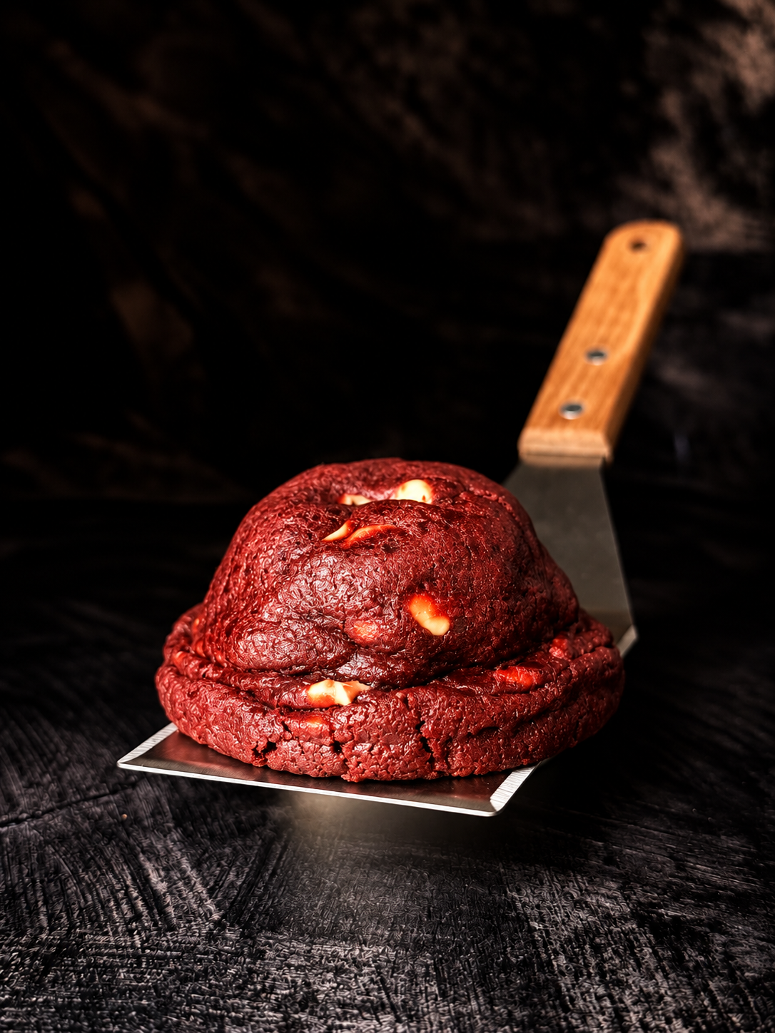 Thick red velvet cookie with white chocolate pieces, handmade in Dartmoor by Black Bird Bakers